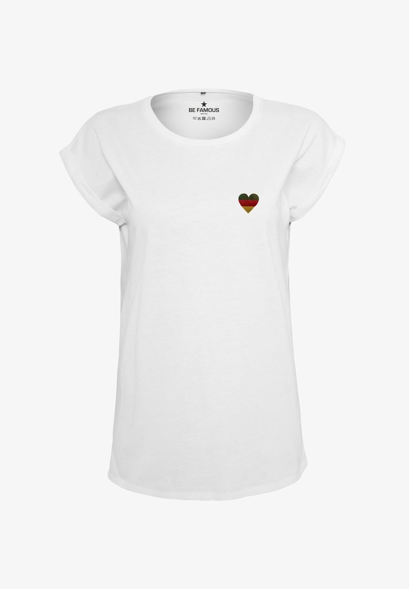 White cotton t-shirt featuring a small heart design in green, red, and black. Classic crew neck with rolled short sleeves.