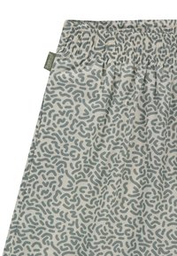 Shorts en tissu de couleur claire avec une taille élastique, ornés d'un motif abstrait vert de formes courbes sur l'ensemble.