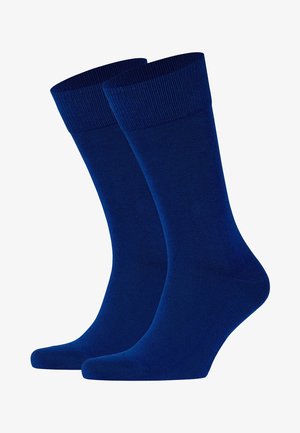 Dunkelblaue Baumwollsocken mit gerippten Bündchen, einer glatten Textur und verstärkten Fersen- und Zehenbereichen für zusätzliche Haltbarkeit.