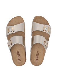 Two gold-tone sandals with two wide straps, featuring buckles and a beige suede insole. The outsole is textured for grip.