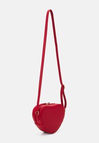 Red heart-shaped crossbody bag made of smooth synthetic material, featuring a thin strap and gold-tone hardware accents.
