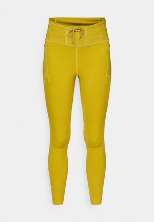 Žlté legíny s priliehavým strihom, vysokým pásom, šnúrkou na stiahnutie, plochými švami a bočným vreckom. Vyrobené z elastického, hladkého materiálu.