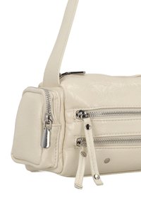 Geantă de mână din piele ecologică de culoare crem, cu formă structurată, accesorii argintii, două buzunare cu fermoar și o curea scurtă pentru umăr.