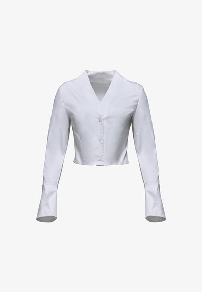 Witte cropped blouse van gladde stof, met lange mouwen en uitlopende manchetten en een V-hals. Knopen aan de voorkant.