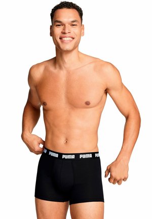 Schwarze Boxershorts mit einem weißen Puma-Logo am Bündchen, aus Stretchstoff, eng anliegendem Design und glatter Textur.