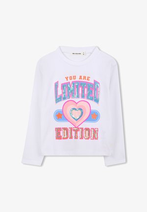 Bijela košulja dugih rukava sa šarenim, sjajnim grafičkim natpisom "TI SI OGRANIČENA EDITIJA" i dizajnom srca u centru.