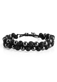 Black bead bracelet made from lava stones and metallic accents, featuring a braided cord and adjustable slip-knot closure.