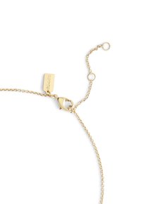Gold chain bracelet with a lobster clasp and a small tag. Features a fine, linked design with a smooth, shiny texture.