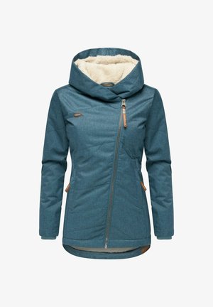 Turquoise capuchonjas met een warme, crèmekleurige binnenvoering; asymmetrische ritssluiting; twee zijzakken; contrasterende beige accenten.