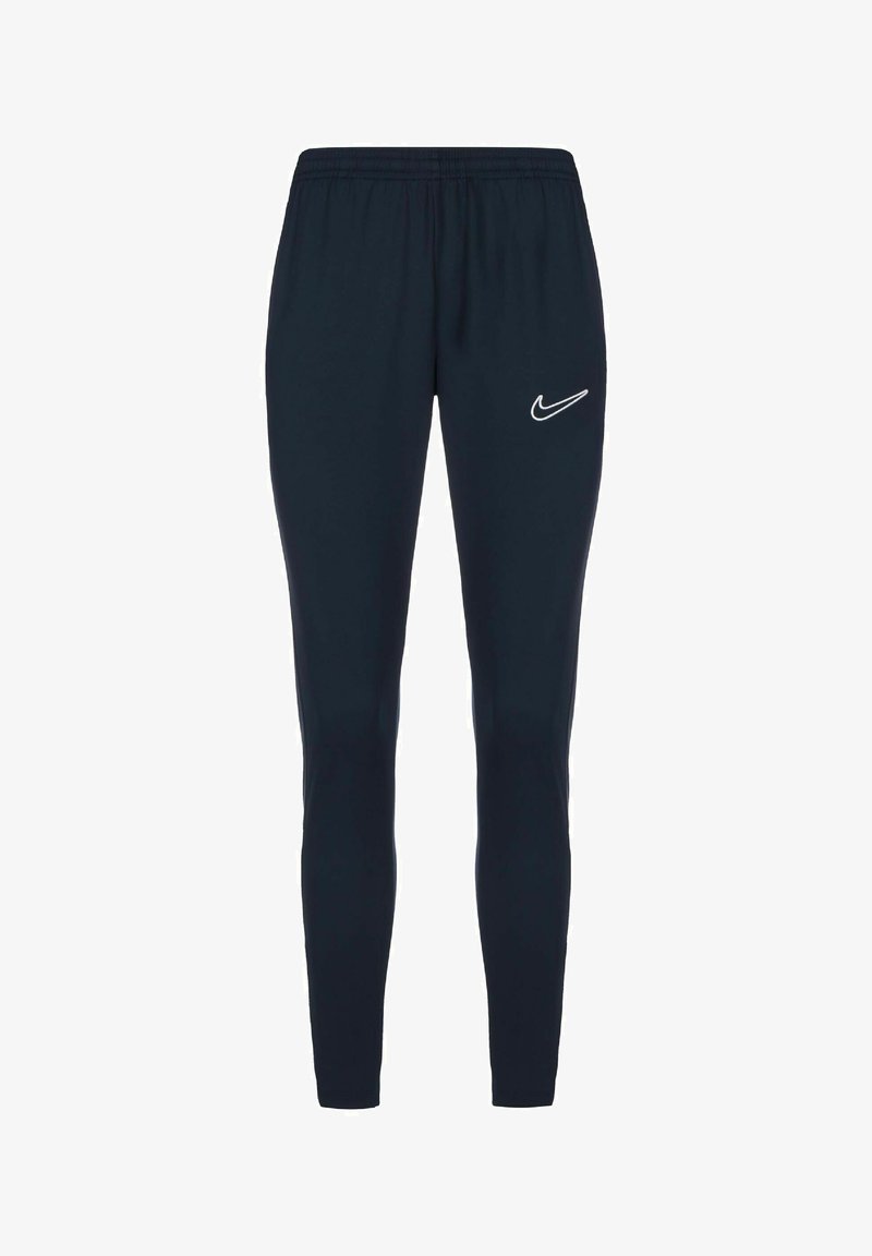 Marineblauwe sportbroek met een elastische tailleband en taps toelopende pasvorm. Met een wit Nike-logo op de linker bovenbeen. Glad stofoppervlak.