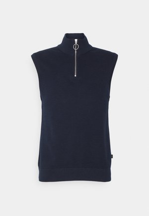Ärmelloses navyblaue Stricktop mit Stehkragen und vorne silbernem Reißverschluss mit rundem Zuggriff.