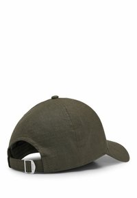 Olive green cap made of textured fabric, featuring a curved brim, adjustable strap at the back, and a small logo on the strap.