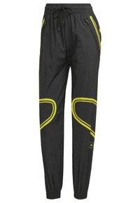 Černé sportovní tepláky s elastickým páskem a manžetami, se zipovými bočními kapsami a žlutými zakřivenými pruhy na nohavicích.