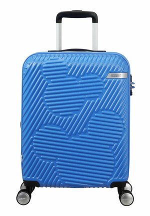 Blue hard-shell suitcase with raised textured design, black handle, silver hardware, and four wheels for easy mobility.