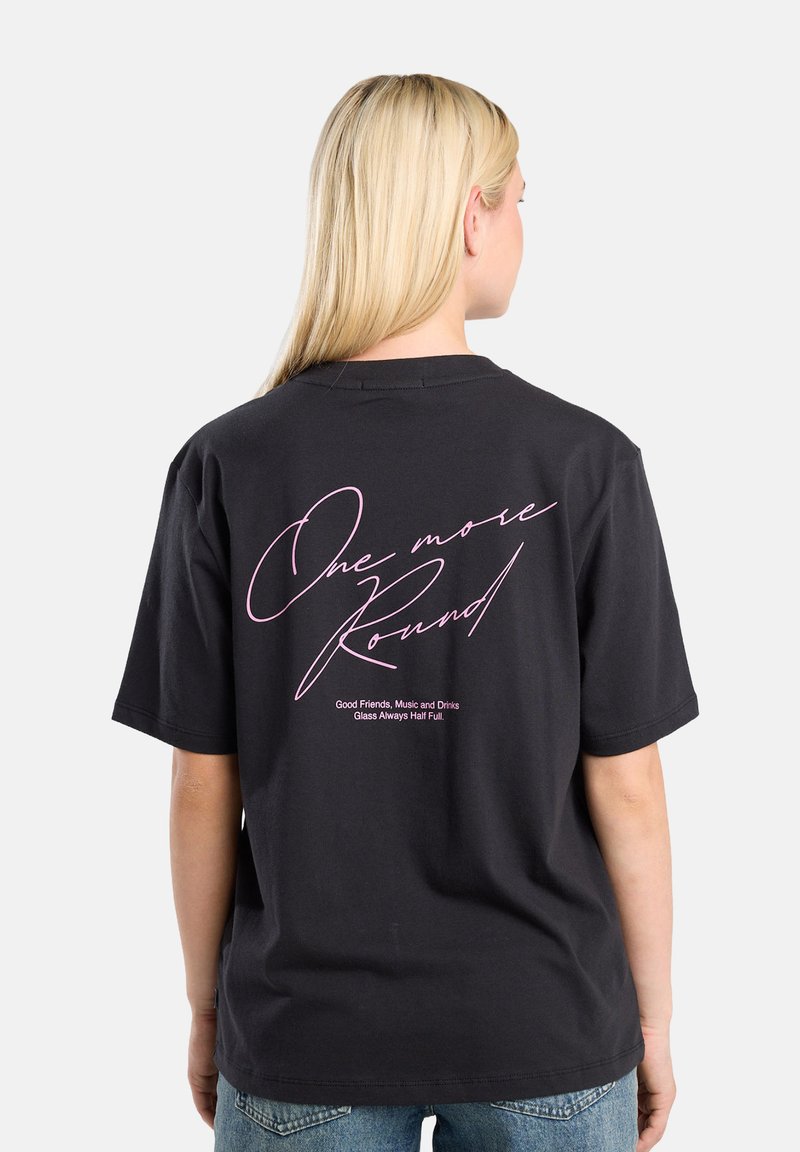 Black cotton t-shirt featuring cursive pink text on the back, stating "One more Round" along with a graphic slogan below. Short sleeves.