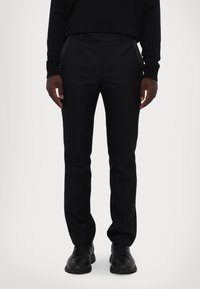 Black tailored trousers with a slim fit, smooth texture, and notch waistband. Features side pockets and subtle rear detailing.