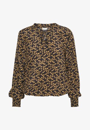 Blouse noire à manches longues avec petits motifs floraux jaunes, col rond avec nouage sur le devant et poignets smockés.