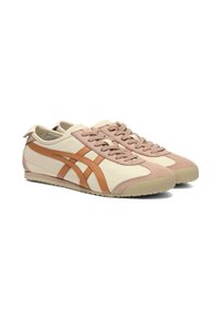 Beige and peach athletic shoes featuring suede and leather materials, a streamlined design, rounded toe, and contrasting side stripes.