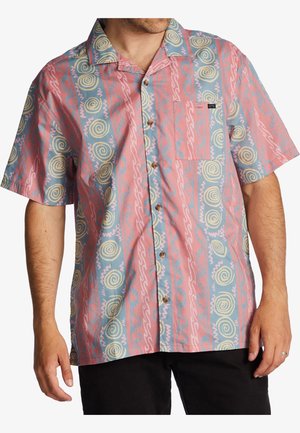 Mand iført en kortærmet skjorte med blå og pink lodrette striber og spiral- og bølgemønstre.