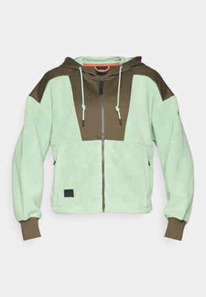 Felpa con zip in pile che presenta pannelli verde chiaro e marrone scuro, un cappuccio con coulisse e una finitura testurizzata. Patch logo nero all'orlo.