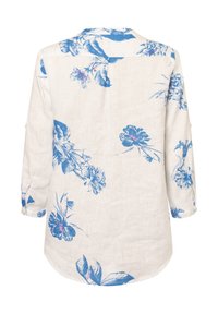 Bluse mit Blumenmuster in Blau- und Weißtönen, aus Leinen gefertigt. Hat lange Ärmel und einen abgerundeten Saum. Die Rückansicht zeigt große Blumenmuster.