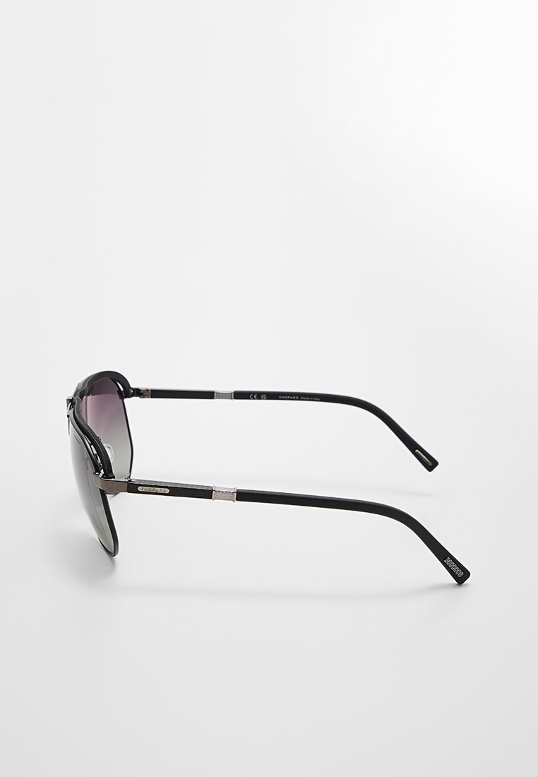Czarne okulary przeciwsłoneczne z gradientowymi soczewkami, elegancki design oprawki, metalowe akcenty na zausznikach oraz zaokrąglone ramiona dla pewnego dopasowania.