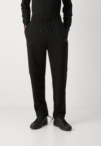 HUGO NIPIPEPANT - Tracksuit bottoms - black