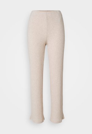 Pantaloni a coste beige chiaro con design a gamba dritta e orlo svasato. Realizzati in un tessuto morbido con una trama sottile. Vita elasticizzata per un comfort ottimale.