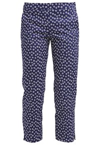 Pantalon marine avec un motif à cercles blancs répété, coupe slim, au tissu lisse et à taille standard.