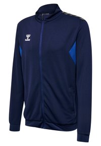 Marinblå zip-up jacka med hög krage, kontrasterande ljusblå sidopaneler, texturerad tyg och broderad logga på bröstet.