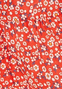 Red fabric with a floral pattern of white and yellow flowers, accented by small blue leaves. Texture appears smooth and lightweight.