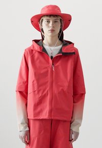 Red waterproof jacket with a hood, front zipper, and short sleeves. Paired with matching pants and a wide-brimmed hat. Smooth texture.