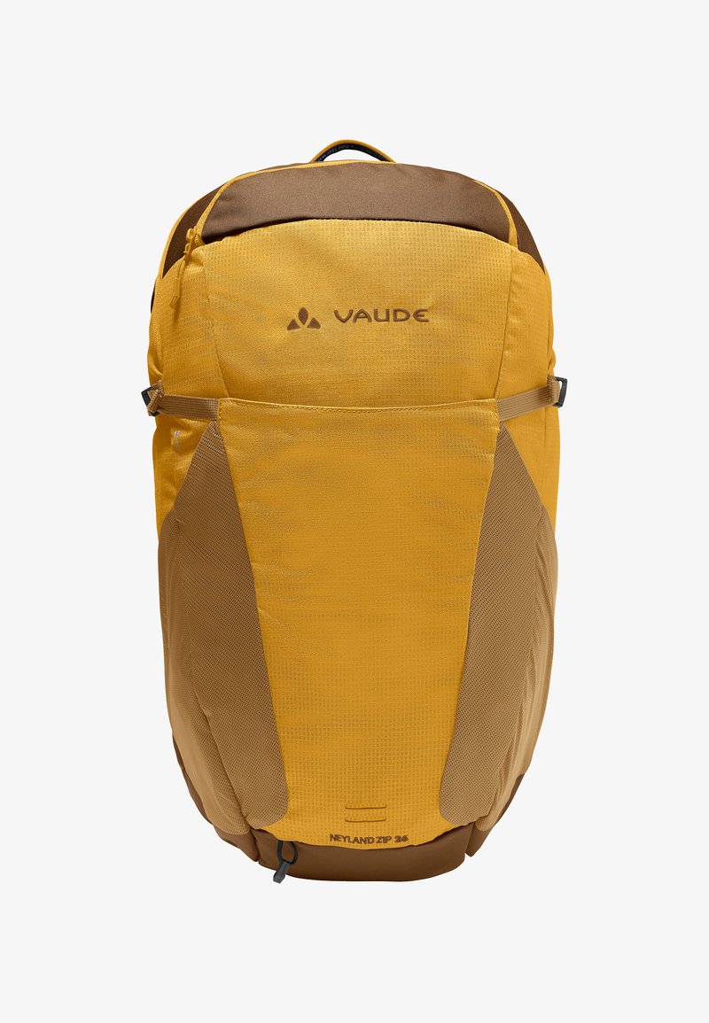 Sac à dos en tissu durable jaune et marron avec un haut arrondi, des panneaux latéraux en maille et un logo discret, muni d'une fermeture zippée et d'une poignée supérieure.