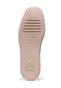 Suola di scarpa in gomma rosa con scanalature e creste testurizzate, che presenta il logo "Cole Haan GRAND.36" al centro in basso.