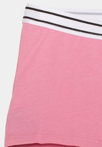 Tessuto a coste rosa con una vita bianca con strisce nere. Texture liscia, design aderente e una leggera elasticità.