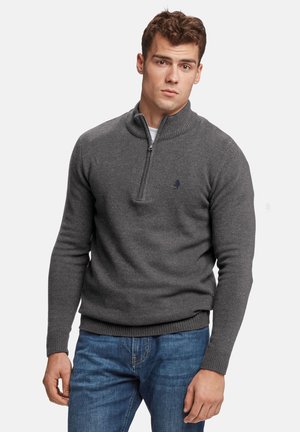 Gray zip-up sweater with a ribbed collar, long sleeves, and fitted design. Features a small logo on the left chest. Worn with blue jeans.