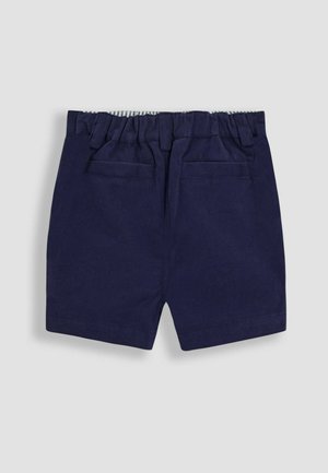 Námořnické modré bavlněné šortky s elastickým pasem, se dvěma zadními kapsami a pruhovanou vnitřní podšívkou. Hladká textura, přizpůsobený střih.