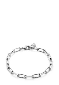 Pulsera de cadena de plata de ley con eslabones alargados, cierre de langosta y un pequeño charm con el logotipo de la marca. Textura suave.