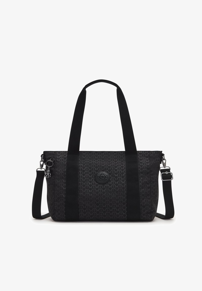 Sac fourre-tout noir en tissu avec un motif texturé. Présente de longues poignées noires, une bandoulière amovible et un patch rond avec logo.