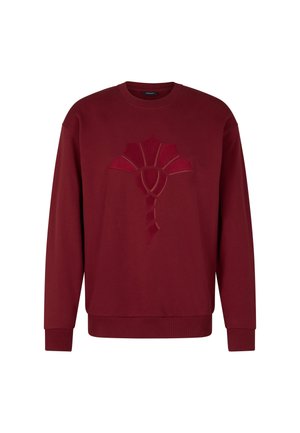 Burgundowa bluza z długim rękawem, z uniesionym, abstrakcyjnym wzorem z przodu. Miękka tkanina z prążkowanymi mankietami i dekoltem.