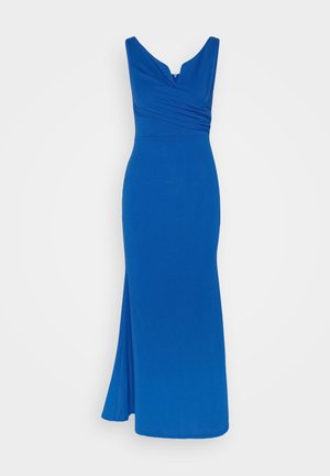 Longue robe bleue en tissu lisse avec un décolleté en V, un corsage froncé et une fente sur le côté pour plus de mouvement.