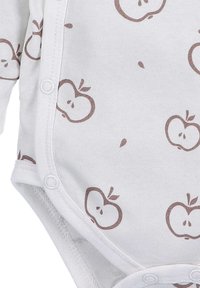 White baby bodysuit featuring a repeated apple pattern in brown. Soft fabric with snap fasteners at the bottom for easy dressing.