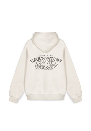 Sudadera crema con capucha ajustable, puños y dobladillo acanalados. Presenta un diseño gráfico en negrita con texto negro en la parte posterior: "MUD CITY INFAMOUS GRMY."