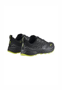 Black running shoes with a textured upper, yellow accents, and a pronounced sole. Features a reinforced heel and patterned design.