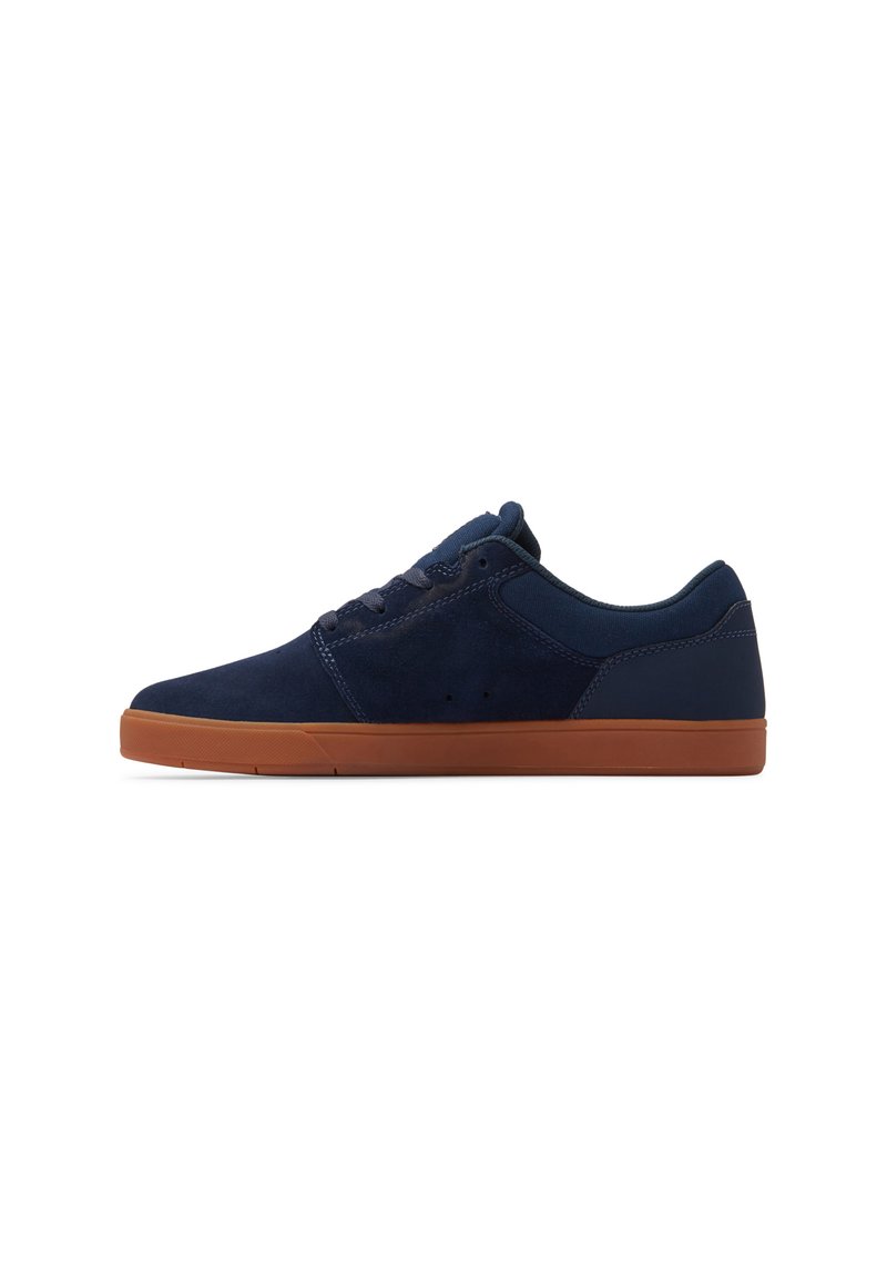 Navy blue suede sneakers featuring a low-profile design, round toe, and a tan rubber outsole with minimal stitching and eyelets.