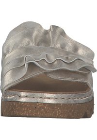 Metallic silver open-toe slip-on shoe featuring a ruffled upper and cork-like sole. Smooth texture and rounded shape with minimal accents.