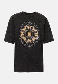 Black oversized T-shirt made of cotton, featuring a centered graphic design with yellow sun and butterflies, accented by white stars.