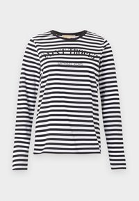 Μαύρο και άσπρο οριζόντια ριγέ πουκάμισο με μακριά μανίκια, με τα κείμενα "SAINT TROPEZ" και "MICHAEL KORS" στο μπροστινό μέρος, λαιμόκοψη τύπου crew.