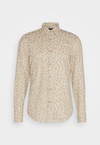 Chemise beige à manches longues avec boutons, col pointu et motif feuillage marron clair sur toute la surface.