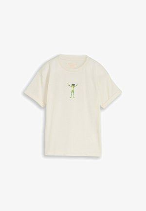 Krótki, kremowy t-shirt z niewielkim zielonym żabkiem w goglach VR nadrukowanym na środku klatki piersiowej.